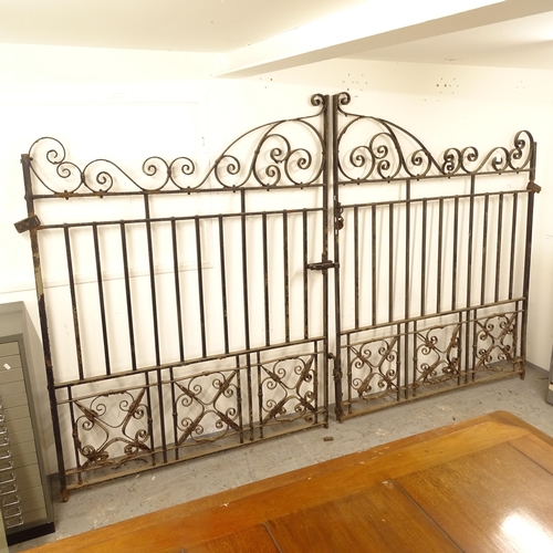 2656 - A large pair of decorative scrolled wrought-iron drive gates, width not including hinged mounts 144c... 