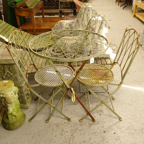 2677 - A folding metal circular-top garden table, and a pair of matching folding chairs