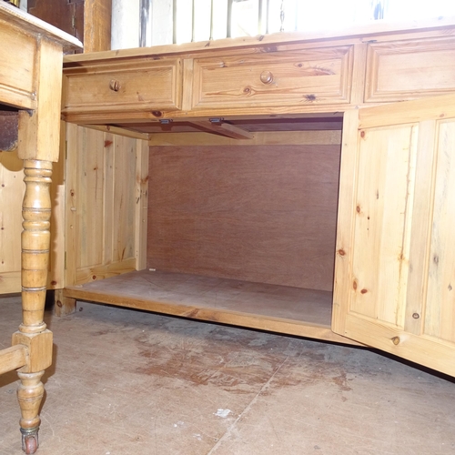 2143 - A large polished pine dresser base, having 4 frieze drawers with 4 panelled cupboard doors under, L2... 