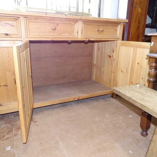 2143 - A large polished pine dresser base, having 4 frieze drawers with 4 panelled cupboard doors under, L2... 