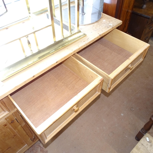 2143 - A large polished pine dresser base, having 4 frieze drawers with 4 panelled cupboard doors under, L2... 