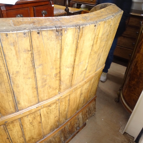 2022 - A large Antique stained pine bow-back settle, H140cm, L165cm