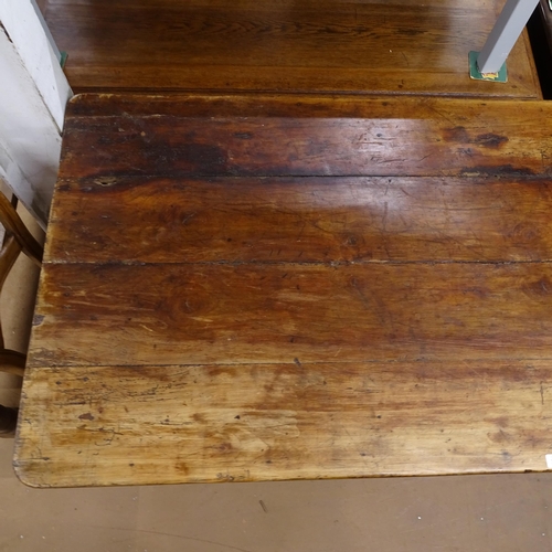 2050 - An Antique elm and pine plank-top kitchen table, with end frieze drawer and opposing slide, raised o... 