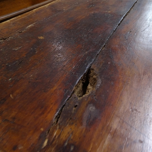 2050 - An Antique elm and pine plank-top kitchen table, with end frieze drawer and opposing slide, raised o... 