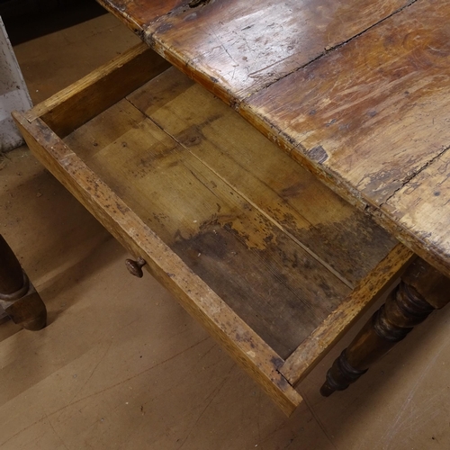 2050 - An Antique elm and pine plank-top kitchen table, with end frieze drawer and opposing slide, raised o... 