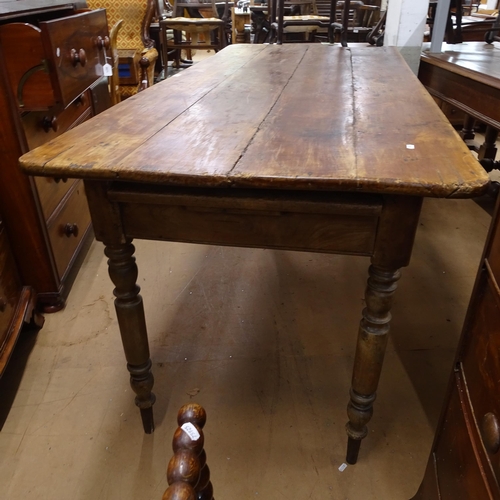 2050 - An Antique elm and pine plank-top kitchen table, with end frieze drawer and opposing slide, raised o... 