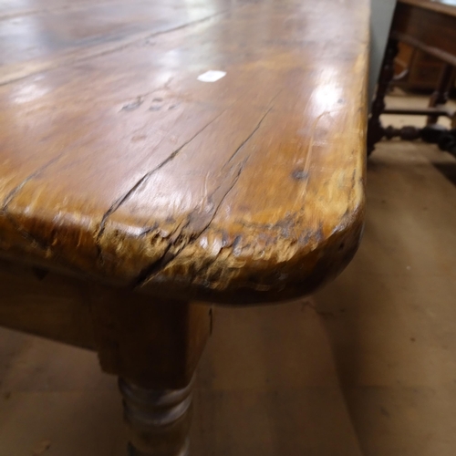 2050 - An Antique elm and pine plank-top kitchen table, with end frieze drawer and opposing slide, raised o... 