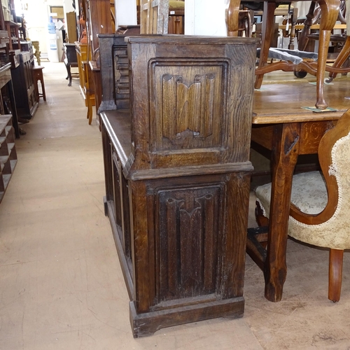 2185 - An Antique oak carved and linenfold panelled hall settle with rising seat, W117cm, H100cm, D41cm