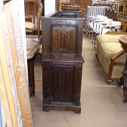 2185 - An Antique oak carved and linenfold panelled hall settle with rising seat, W117cm, H100cm, D41cm