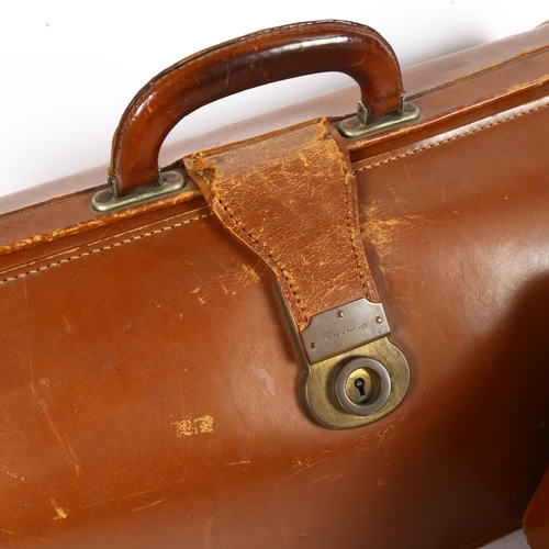 114 - A leather Gladstone bag, and similar vanity case (2)