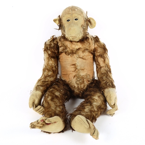 126 - A large Vintage straw-filled monkey toy, possibly Steiff, height 70cm