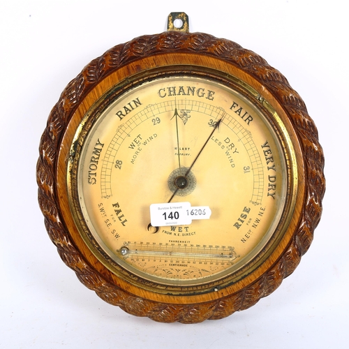 140 - An oak rope-framed aneroid wall barometer and thermometer, by W Last of Sudbury, diameter 29cm