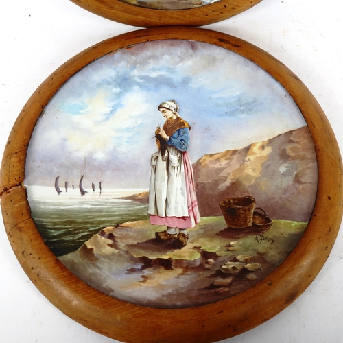 253 - A pair of large 19th century French ceramic wall plates, with hand painted designs of fisher girls, ... 