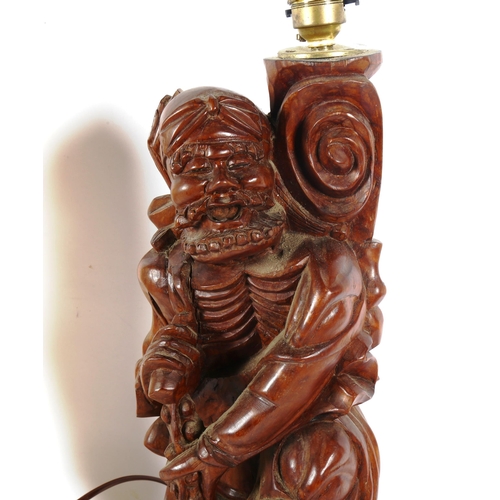 255 - A large Chinese carved hardwood figural lamp, and a similar resin example, largest height 55cm (2)