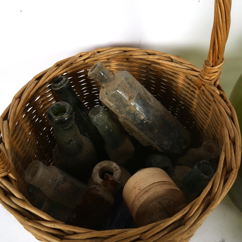 260 - Various glass bottles, demijohn, a wicker basket etc