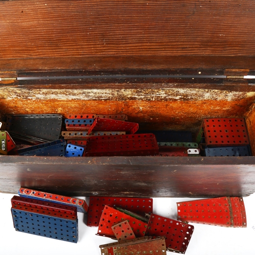 366 - A stained pine chest, containing Vintage Meccano