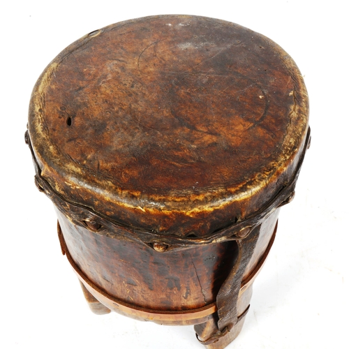 389 - An African Tribal animal skin covered drum, height 38cm