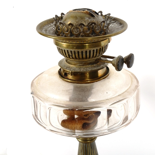 395 - An Art Deco brass oil lamp, with glass font, height 40cm