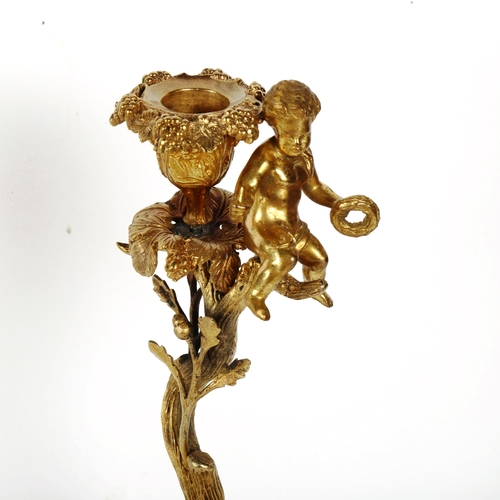 403 - A 19th century gilt-brass putti and acorn candlestick, with ram's head and hoof feet, height 30cm