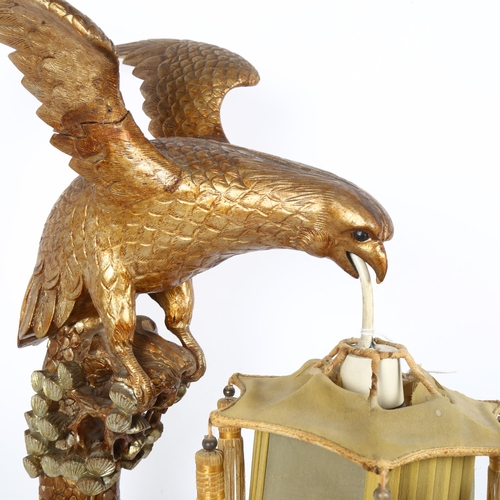 323 - A Chinese carved and painted wood bird of prey table lamp, with silk lantern shade, height 60cm