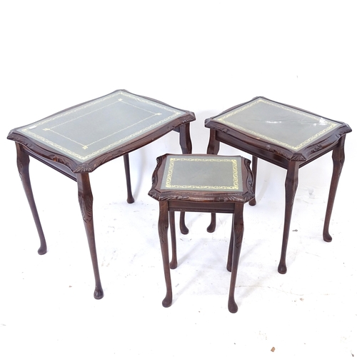 2060 - A nest of 3 reproduction mahogany occasional table, with inset glass tops, largest W56cm, H53cm, D42... 