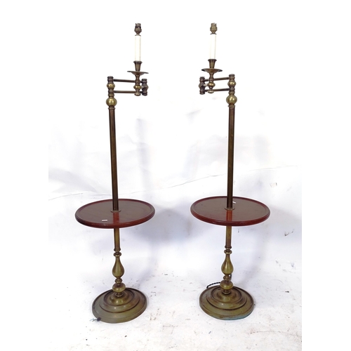 2068 - A pair of brass and mahogany library standard lamps, with integral shelf and adjustable arm, height ... 