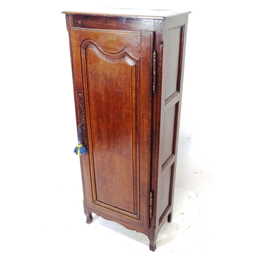 2074 - A 19th century French narrow oak single-door cupboard, with shaped panelled door, width 62cm, height... 