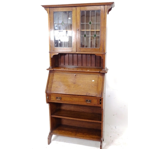 2077 - A 1920s oak student's bureau bookcase, with 2 leadlight glazed doors, W80cm, H84cm, D34cm (with key)