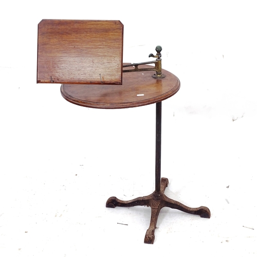 2079 - An Antique mahogany music stand, with adjustable stand and integrated table, on cast-iron base