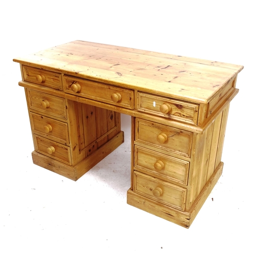 2086 - A polished pine pedestal desk with 9 drawers, W121cm, H77cm, D60cm