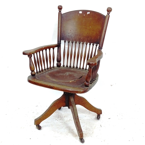 2127 - An early 20th century swivel desk chair (leather upholstery A/F)