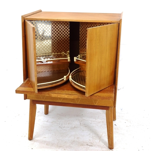 2129 - A mid-century cocktail cabinet, the pull-out slide opening the mirrored interior, with drawer under,... 