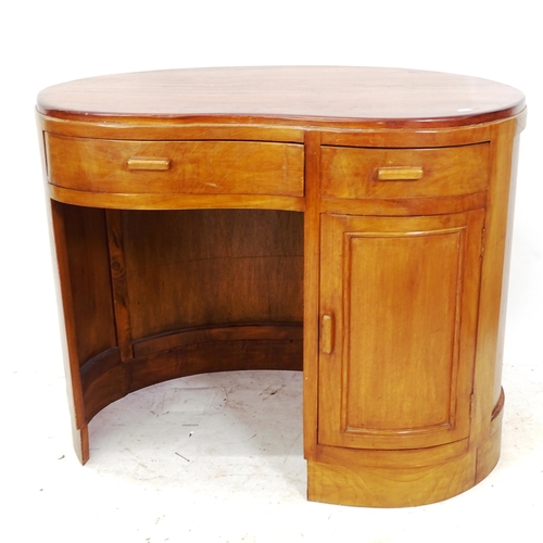 2133 - A mid-century mahogany kidney-shaped kneehole writing desk, with 2 frieze drawers and cupboard under... 