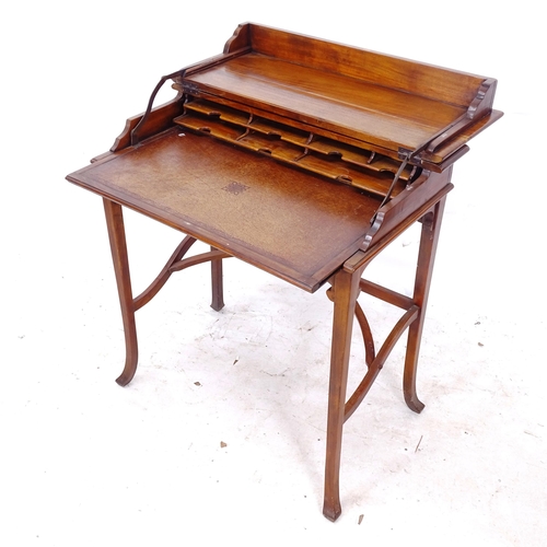 2270 - An Edwardian mahogany metamorphic writing table/desk, the fold over top opening to reveal a fitted i... 