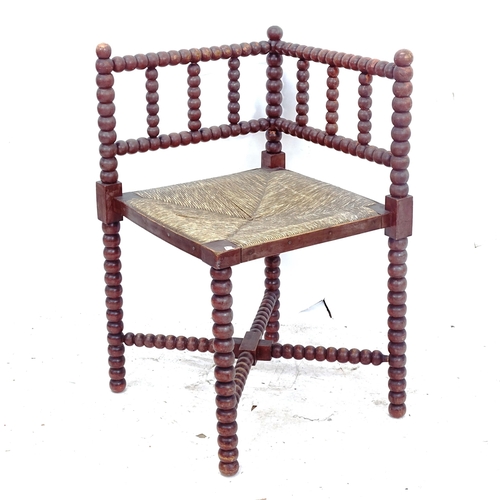 2274 - An Antique rush-seated bobbin turned corner chair