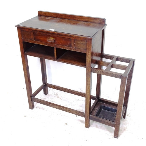 2309 - A 1930s oak hall table with integrated stick/umbrella stand, W88cm, H86cm, D31cm