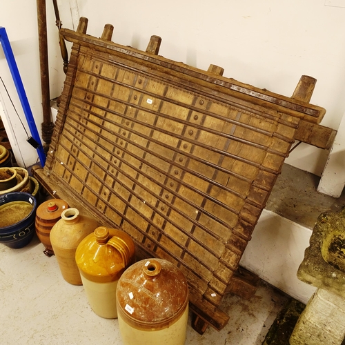 2691 - An Antique Indian teak and metal-bound elephant Howdah saddle converted to a low table, L180cm