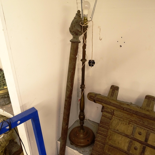 2692 - A mahogany curtain pole with carved finials, L170cm, and a brass standard lamp