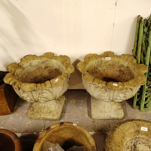 2701 - A pair of weathered concrete tulip design garden planters on stand, W50cm, H44cm