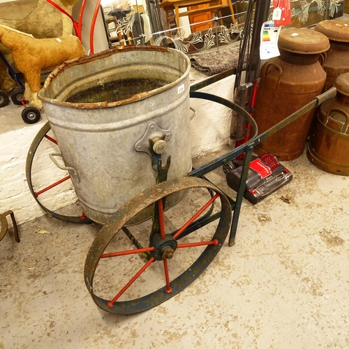 2710 - A galvanised metal water carrier on wheeled trolley