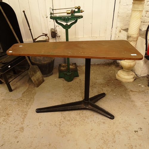 2729 - A copper-clad triangular top table on cast-iron base, W107cm