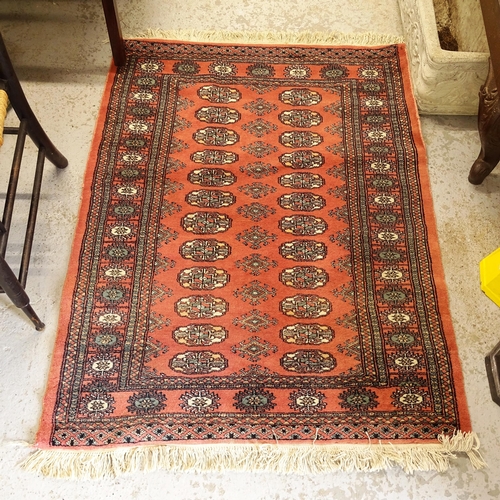 2751 - A salmon ground Afghan Tekke rug, 128cm x 97cm