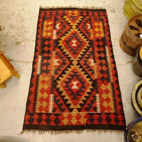 2754 - A black ground Kilim rug, 132cm x 90cm