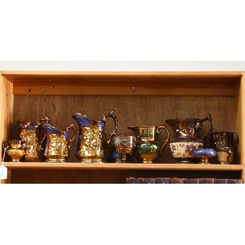 770 - A graduated set of copper lustre jugs, tallest 19cm, and other lustre jugs and pots