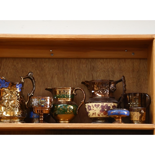 770 - A graduated set of copper lustre jugs, tallest 19cm, and other lustre jugs and pots