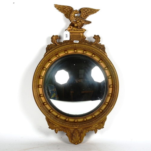 804 - A reproduction Regency style gilt-framed convex wall mirror, height 68cm