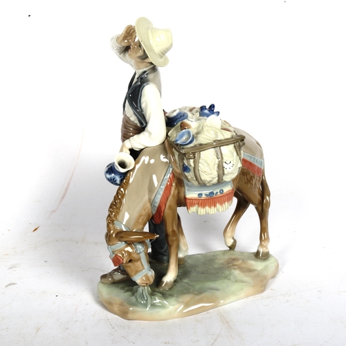 811 - A Lladro porcelain figural group, man with donkey, height 27cm