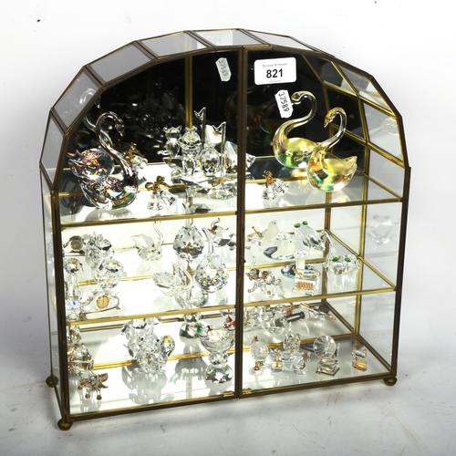 821 - A group of Swarovski Crystal Collection animals and ornaments, in glazed mirror-back case