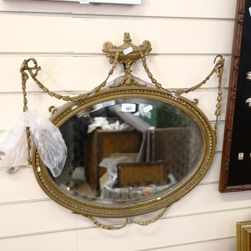 867 - A Neo-Classical style gilt-framed ribbon swag oval wall mirror, height 56cm, width 55cm