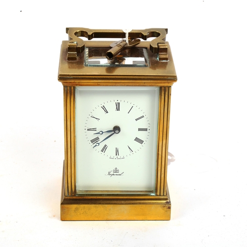 868 - An Imperial brass-cased carriage clock, white enamel dial with Roman numeral hour markers and glass ... 